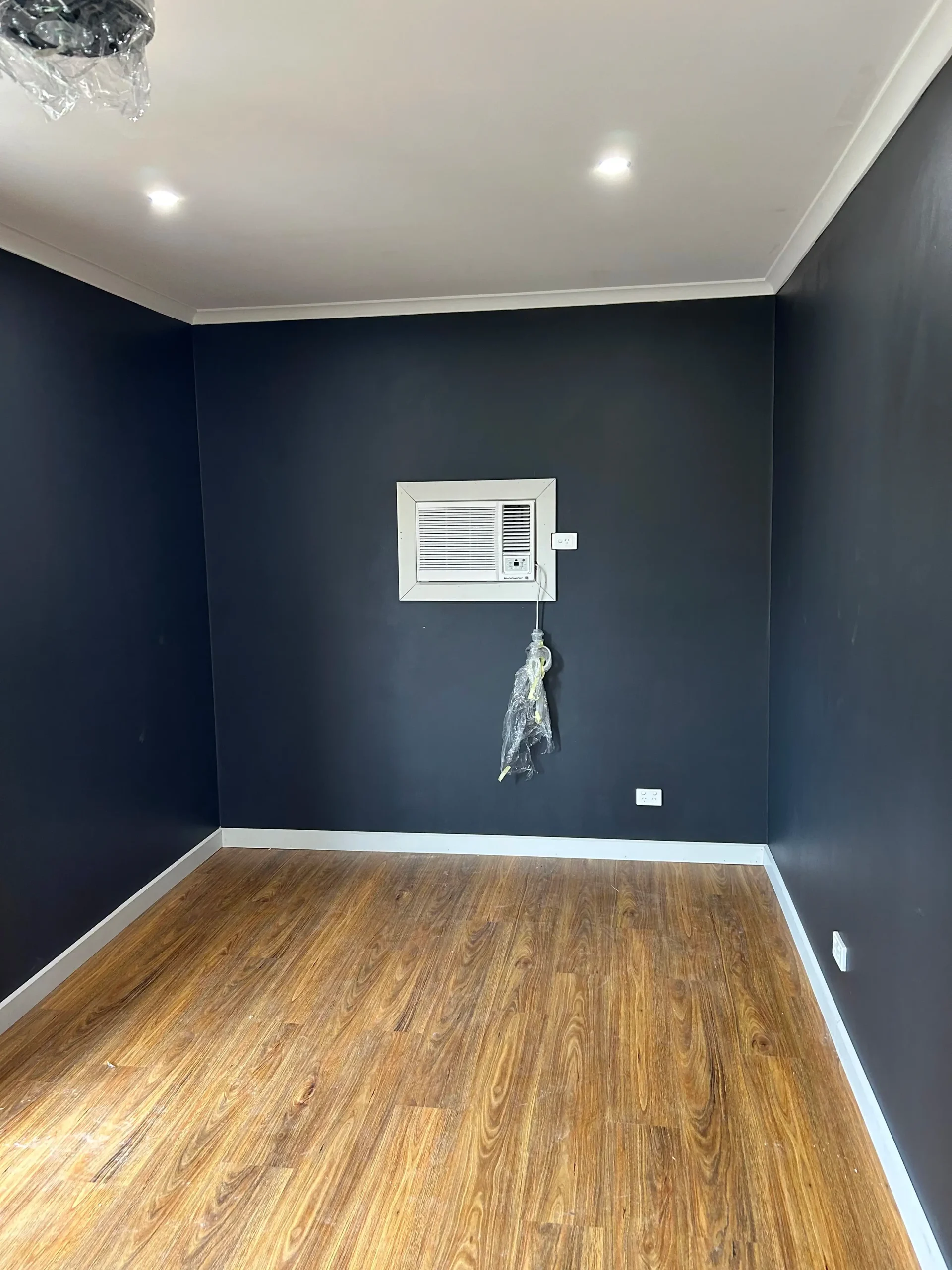 Completed garage conversion interior in Adelaide with new flooring, insulated lined walls and cooling